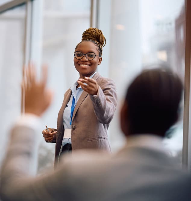 Happy,African,American,Businesswoman,Aiming,At,One,Of,Colleagues,Who