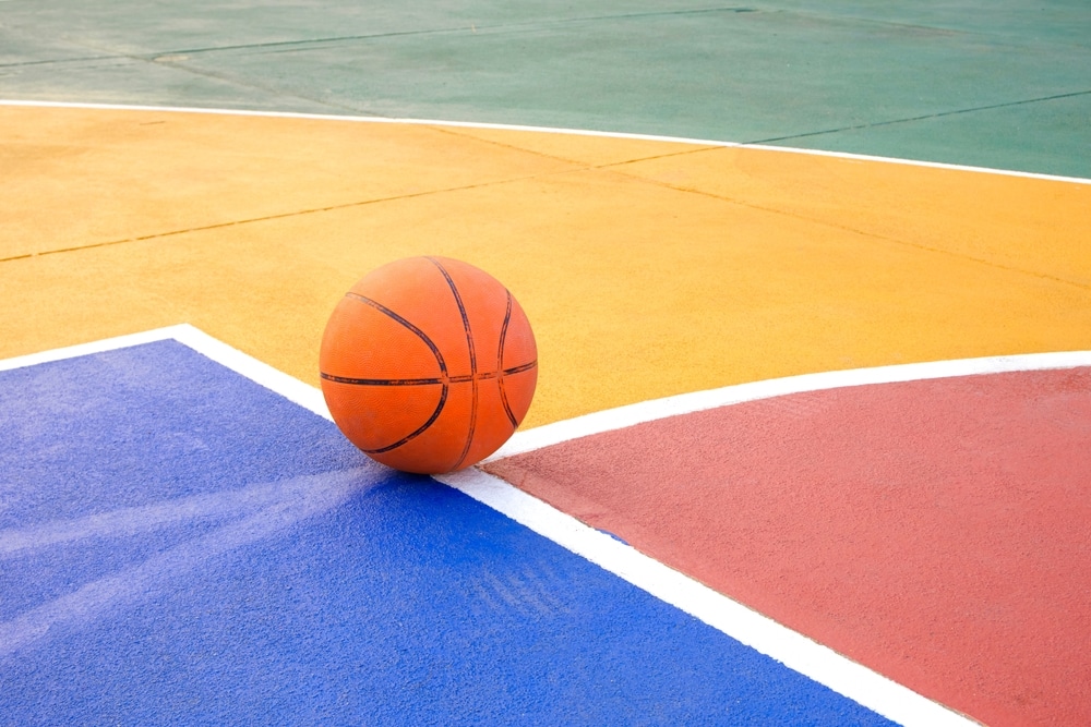 Basketball,On,Outdoor,Basketball,Court,With,Colorful,Pattern,On,Concrete