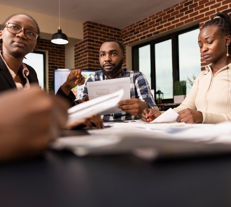 Black,Colleagues,Work,Together,At,Conference,Table,,Reviewing,Financial,Paperwork